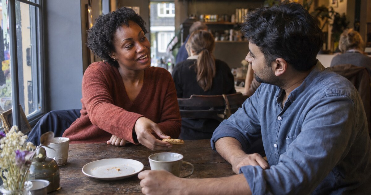 In a small neighbourhood café in the late afternoon, a Black woman in her early thirties with short natural curls and a plain rust-coloured…
